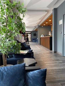 an office lobby with blue pillows and a row of chairs at Brzeće Center Studio Mitrovski Gondola 300m in Kopaonik