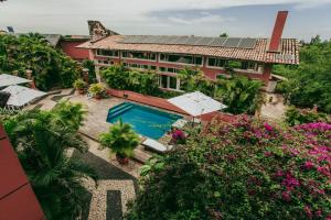 an aerial view of a resort with a swimming pool and flowers at Aimberê Eco Resort Hotel in Coqueiro
