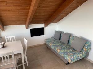 a living room with a couch and a table at Agriturismo "I Castellari" in Pietra Ligure