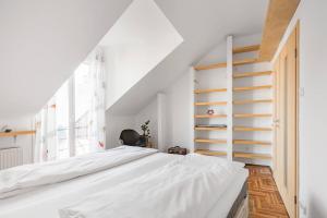 A bed or beds in a room at Relax Into Loft Living At A Light-Filled City Escape