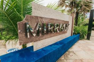 a sign for the entrance to a garage at Aimberê Eco Resort Hotel in Coqueiro