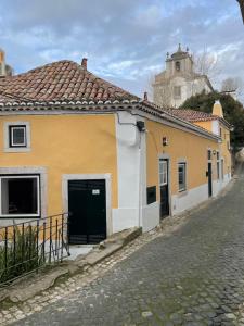 a yellow and white building on the side of a street at Sintra1012 Boutique Guesthouse in Sintra