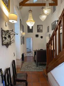 a hallway with chairs and chandeliers in a house at Sintra1012 Boutique Guesthouse in Sintra