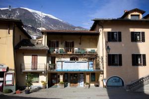 a group of buildings with a mountain in the background at Hotel La Piazzetta in Limone Piemonte