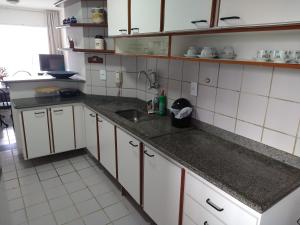 a kitchen with a sink and a counter top at Sossego no Centro e vista para o Mar in Guarapari
