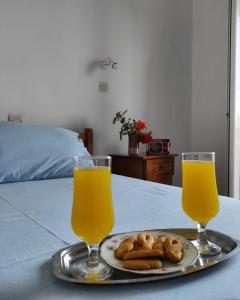 un plato de comida y dos vasos de zumo de naranja en studios.maria.anna, en Kamilari