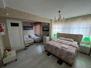 a bedroom with a bed and a living room at SAYDAM OTEL in Seyhan