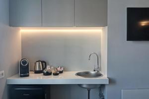 a kitchen with a sink and a light on the counter at Vicolo Fiore Affittacamere II in Matera