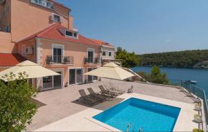 a house with a swimming pool next to a building at Villa Iva Osibova in Milna