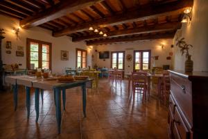 a large kitchen and dining room with tables and chairs at Agriturismo La Banchella in Scarlino