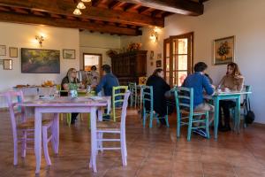 a group of people sitting at tables in a restaurant at Agriturismo La Banchella in Scarlino +22 photos