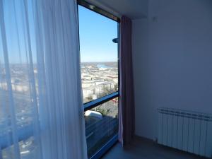 a room with a large window with a view of a city at AP RELAX Tulcea in Tulcea