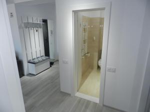 a white bathroom with a toilet and a mirror at AP RELAX Tulcea in Tulcea +19 photos