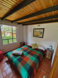 Llit o llits en una habitació de EL REFUGIO Cabaña Campestre