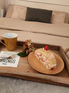 a slice of cake on a tray on a bed at Suite - Sweet MayLeen in Merano +19 photos