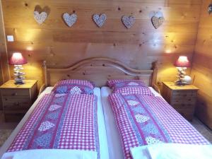 a bedroom with two beds with hearts on the wall at Apartment mit Traumblick im Haus Olympia in Grächen