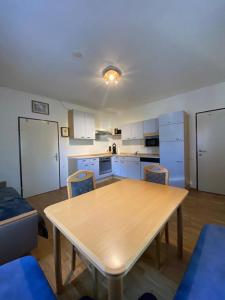 a kitchen with a table and chairs in a room at FeWo Teusch Top1 in Arnoldstein