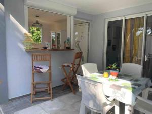 a kitchen with a table and chairs and a dining room at La villa ô plaisir in Deshaies