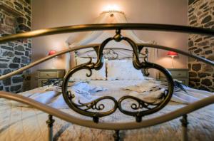 a bedroom with a bed with a lamp on it at Palaeopoli Villas in Avlemonas