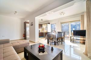 a living room with a couch and a table at Lake View Suites in Kávallos