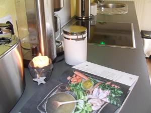 a candle and a plate of food on a counter at Ferienwohnung Hochwald - im Herzen des Saarlandes in Quierschied