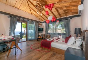 a bedroom with a large bed with a view of the ocean at Club Porto Amore Hotel Adults Only in Alanya