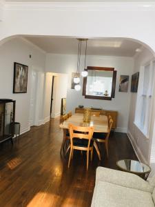 a dining room with a table and a couch at Logan Square Modern Apartment in Chicago