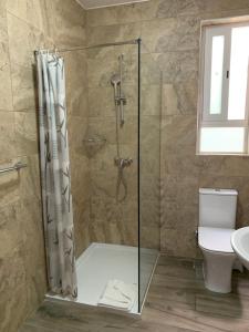 a shower with a glass door in a bathroom at Mon-Chery in San Ġwann