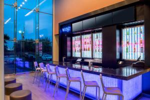 
an entertainment center with a large screen tv at Aloft New York LaGuardia Airport in Queens
