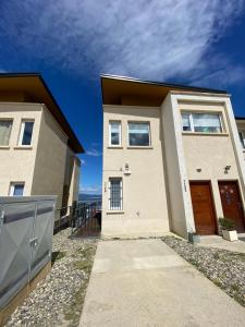 a large house with a driveway in front of it at Waia Apartments in Ushuaia