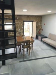 a living room with a table and chairs and a couch at Casa Sofia in Vila Pouca de Aguiar +12 photos