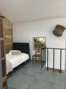 a bedroom with a bed and a chair in a room at Casa Sofia in Vila Pouca de Aguiar +12 photos