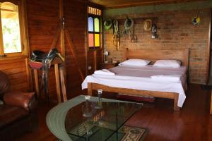 a bedroom with a bed and a glass table at Finca Chalet La Tawa in Sevilla