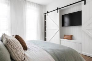 a bedroom with a bed with a flat screen tv at Currumbin Sanctuary Beach Abode in Gold Coast