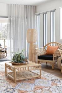 a living room with two chairs and a coffee table at Currumbin Sanctuary Beach Abode in Gold Coast
