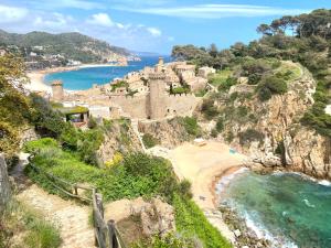 a view of a beach next to the ocean at Sailor Apartment sea views in Tossa de Mar