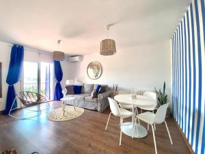 a living room with a table and chairs at Sailor Apartment sea views in Tossa de Mar