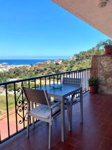 a table and chairs on a balcony with the ocean at Sailor Apartment sea views in Tossa de Mar