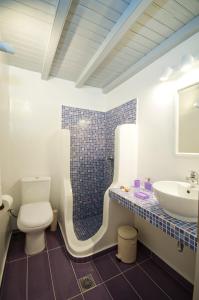 a bathroom with a toilet and a sink at Mykonos Marina in M&yacute;konos City