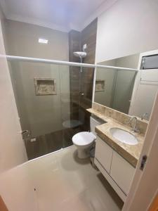a bathroom with a shower and a toilet and a sink at Casa Temporada - São Jose in São José da Coroa Grande +20 photos