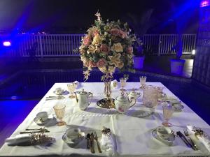 a table with a vase of flowers on it at Hotel Pousada Irmaos Freyhardt in Rio de Janeiro +37 photos