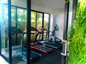 a gym with two tread machines and a mirror at Smile Hua-Hin Resort - SHA Plus in Hua Hin