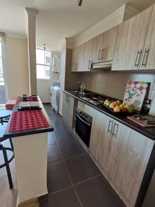 a kitchen with a counter with fruits on it at Departamento Villarrica in Villarrica