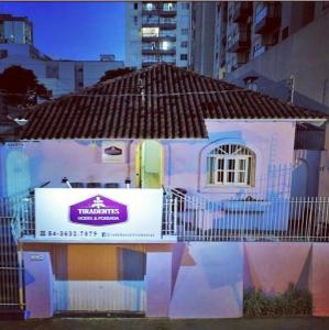 a small house with a sign on the side of it at Hostel e Pousada Tiradentes 774 in Passo Fundo
