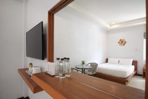 AKARD Private Villas Sattahip في ساتاهيب: غرفة بسرير وطاولة مع مرآة