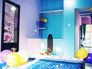 a bedroom with balloons and a bed with a mirror at Hiremane Residency in Sringeri