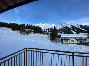 a view of a snowy mountain from a balcony at Moderne Kaminstube in Ramsau am Dachstein