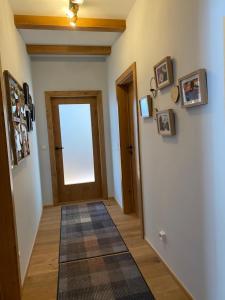 a hallway with a door and a rug at Moderne Kaminstube in Ramsau am Dachstein