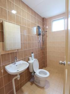 a bathroom with a toilet and a sink at Eden 8pax 3Rooms apartment near Kuching Airport in Kuching
