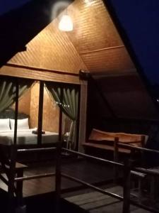 an attic room with two beds and a ceiling at บ้านนอก คอกนา คาเฟ่ เพชรบุรี in Ban Tha Kham